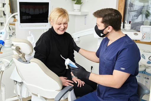 Dentist discussing treatment with patient in dental chair